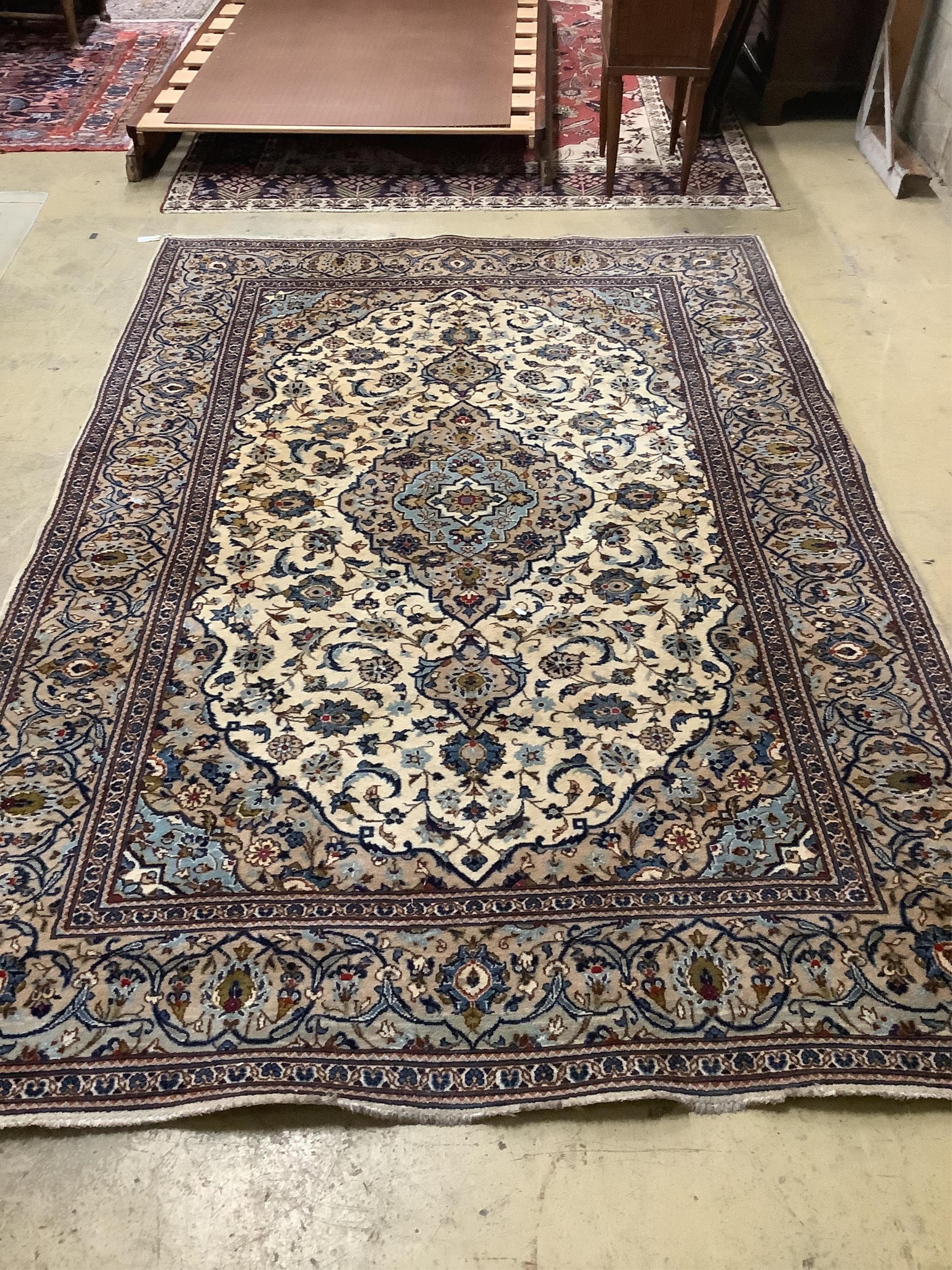 A Tabriz ivory ground carpet, 294 x 198cm. Condition - fair